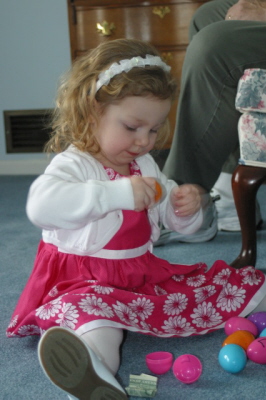 Lizzie Tries Hard To Open The Egg